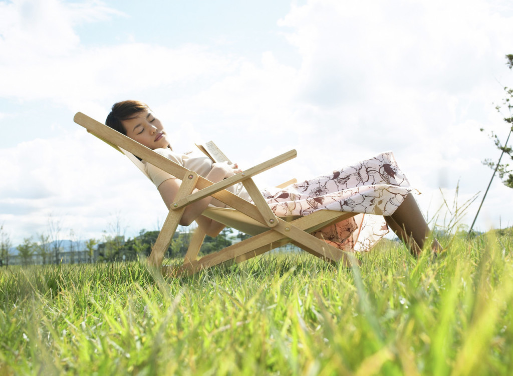 Young Woman Sleeping on Lawn Chair --- Image by © Royalty-Free/Corbis